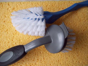 An image showing two cleaning brushes on a yellow cleaning cloth.